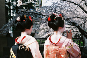 Geisha women posing for the camera in Kyoto