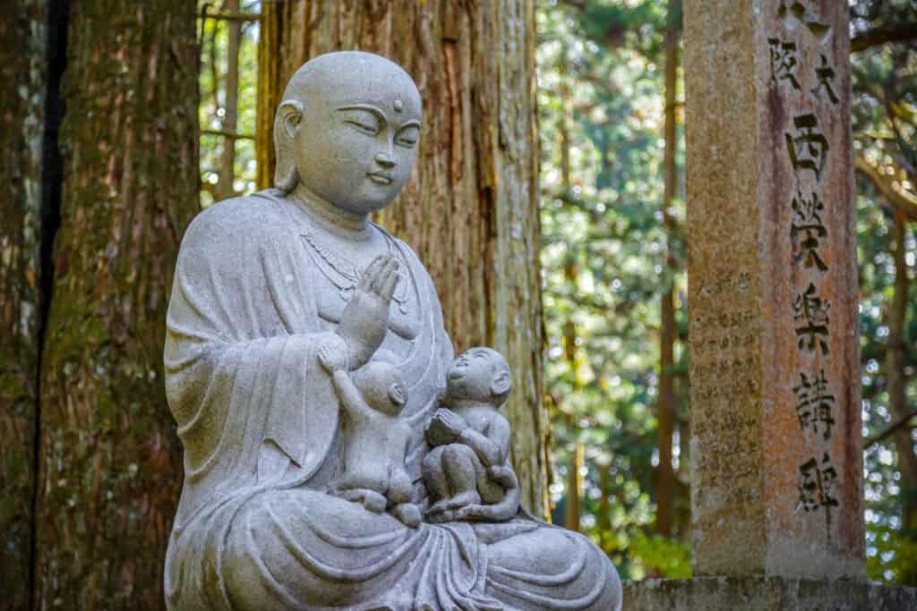 A person sitting in zazen meditation on a cushion in a temple hall