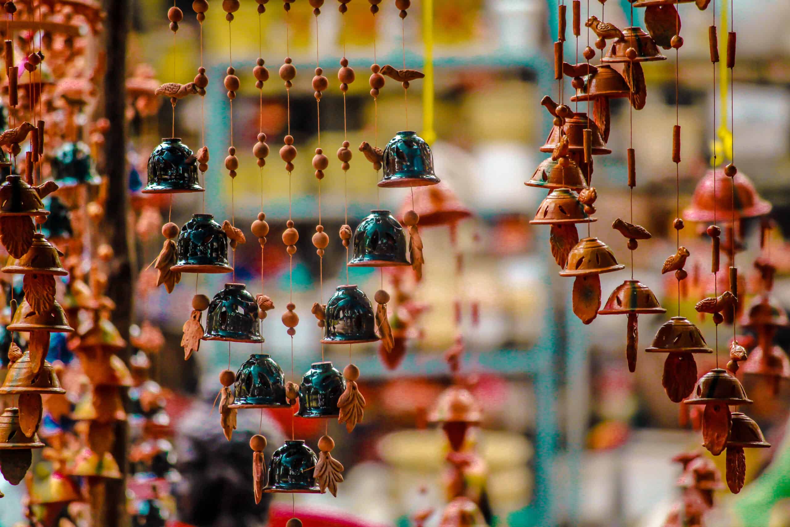Rows of handmade ceramic and glass wind chimes hanging at a market in Kyoto