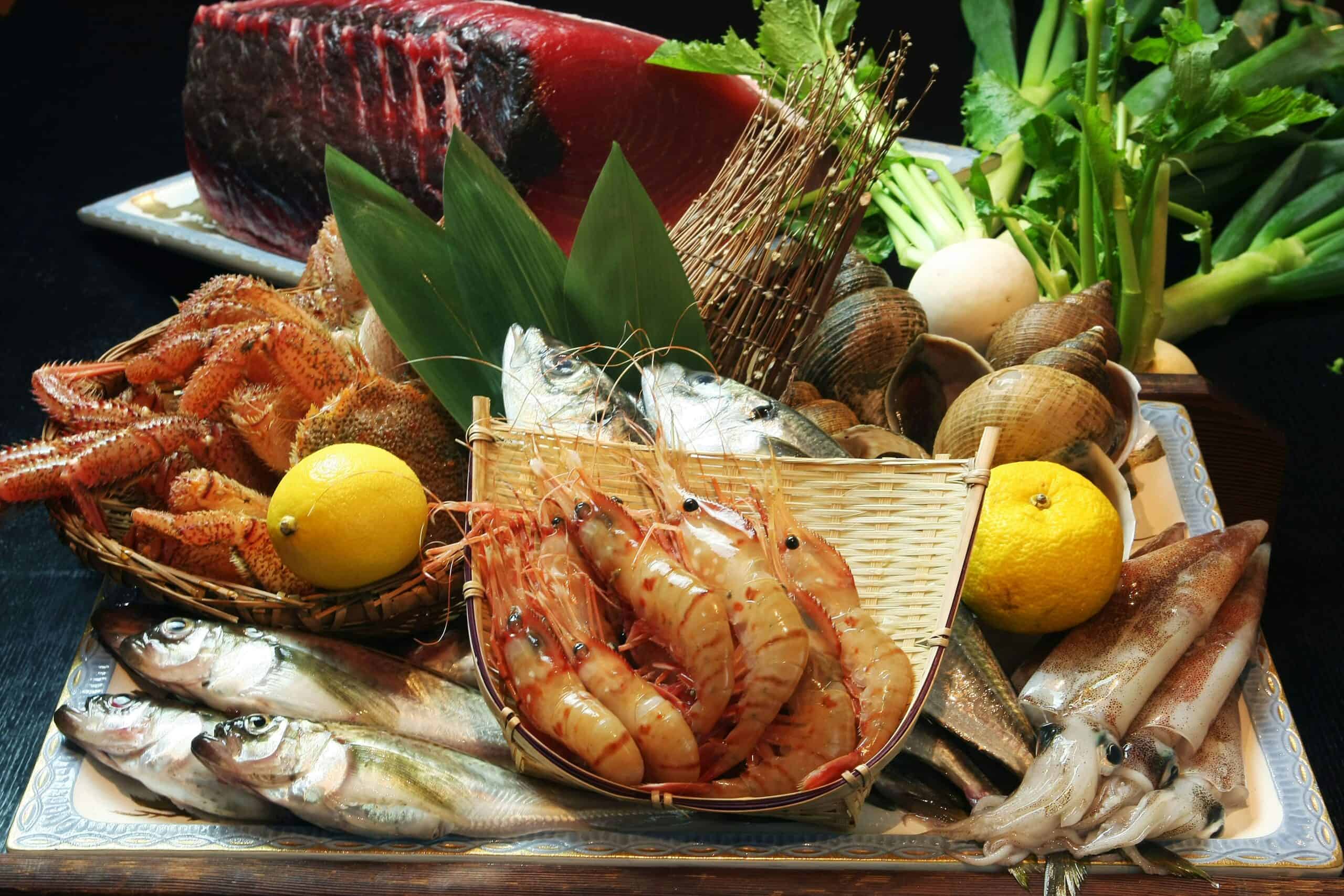 A display of fresh shrimp, fish and shellfish with yuzu and greens, the kind of seafood bought for the New Year