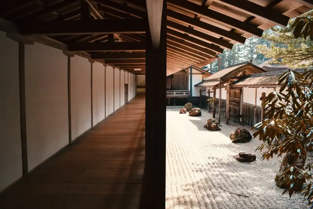 The space between stimulus and response pictured as a long wooden corridor beside a raked gravel garden in Japan