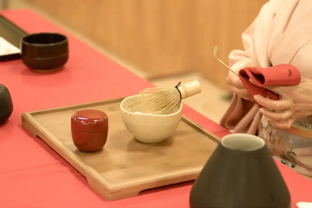 A host preparing tea utensils before a tea ceremony