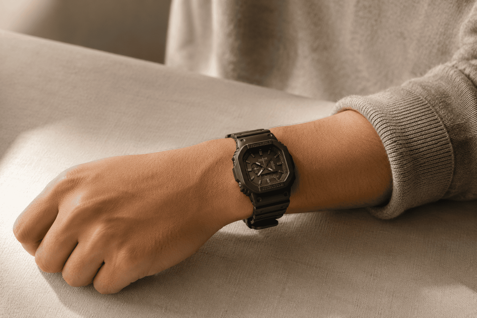 A black G-Shock worn on the wrist with otherwise plain styling — one reference, the rest of the outfit held back