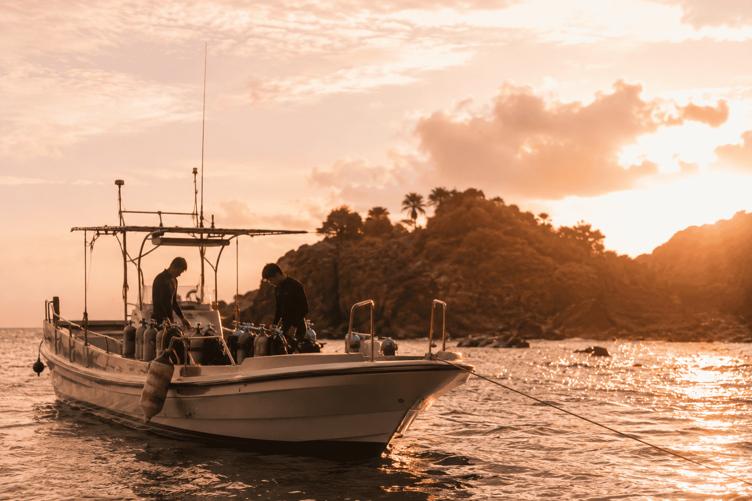 A dive boat anchored off the Okinawa coast at golden hour
