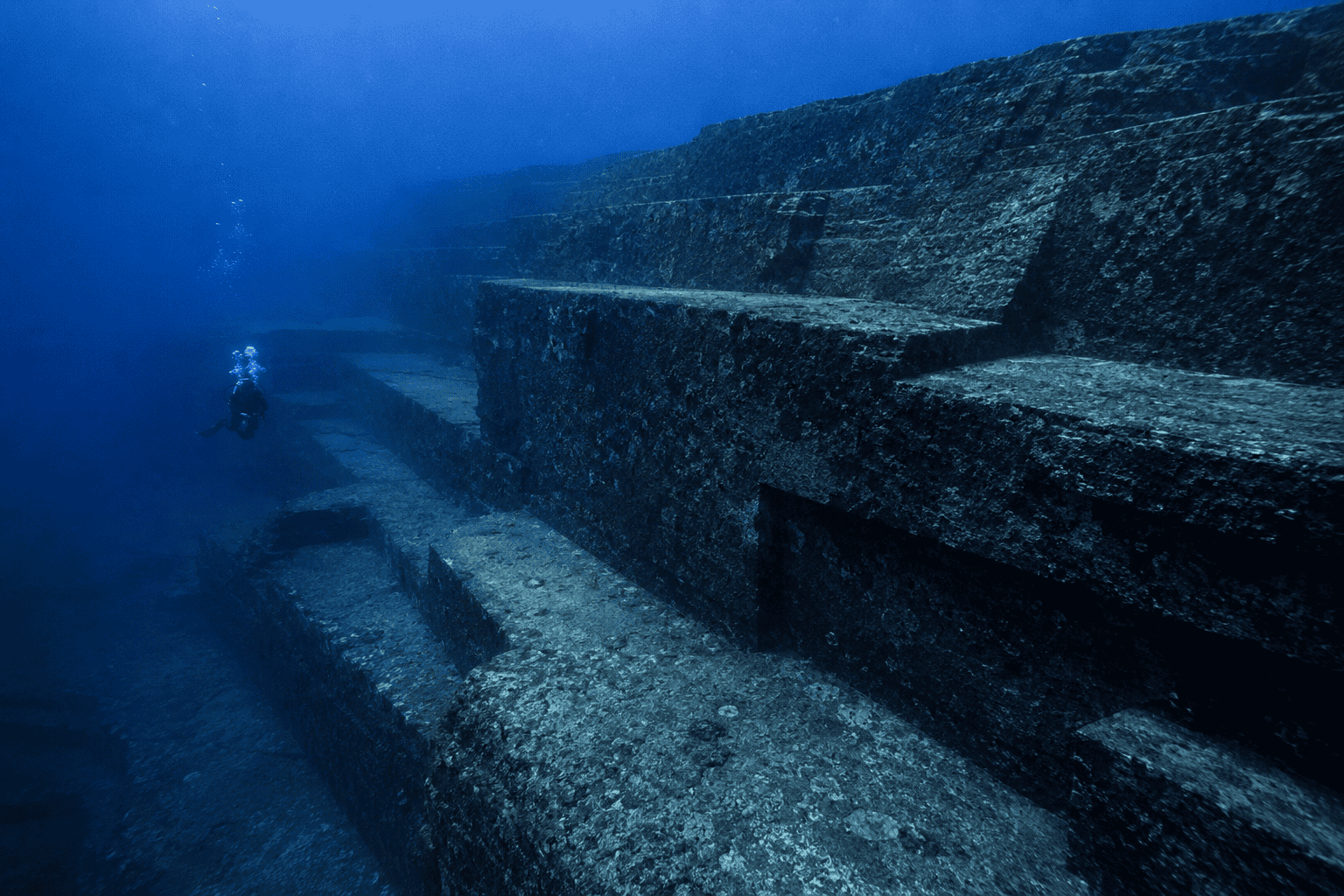The Yonaguni underwater monument descending into deep blue water