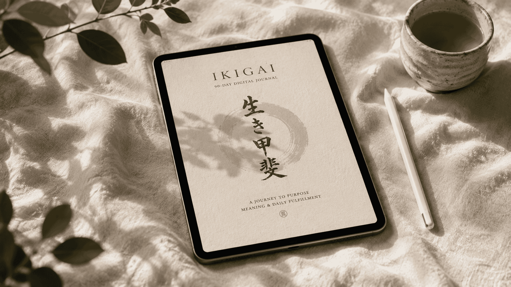 The Ikigai journal open on a cream desk, set for daily reflection
