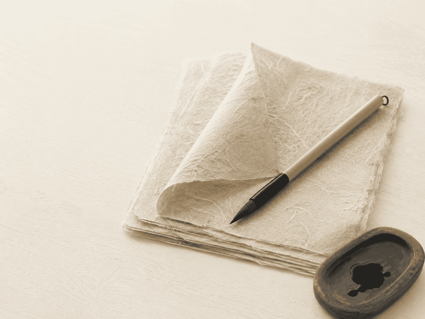 Sheets of Japanese washi paper with a calligraphy brush
