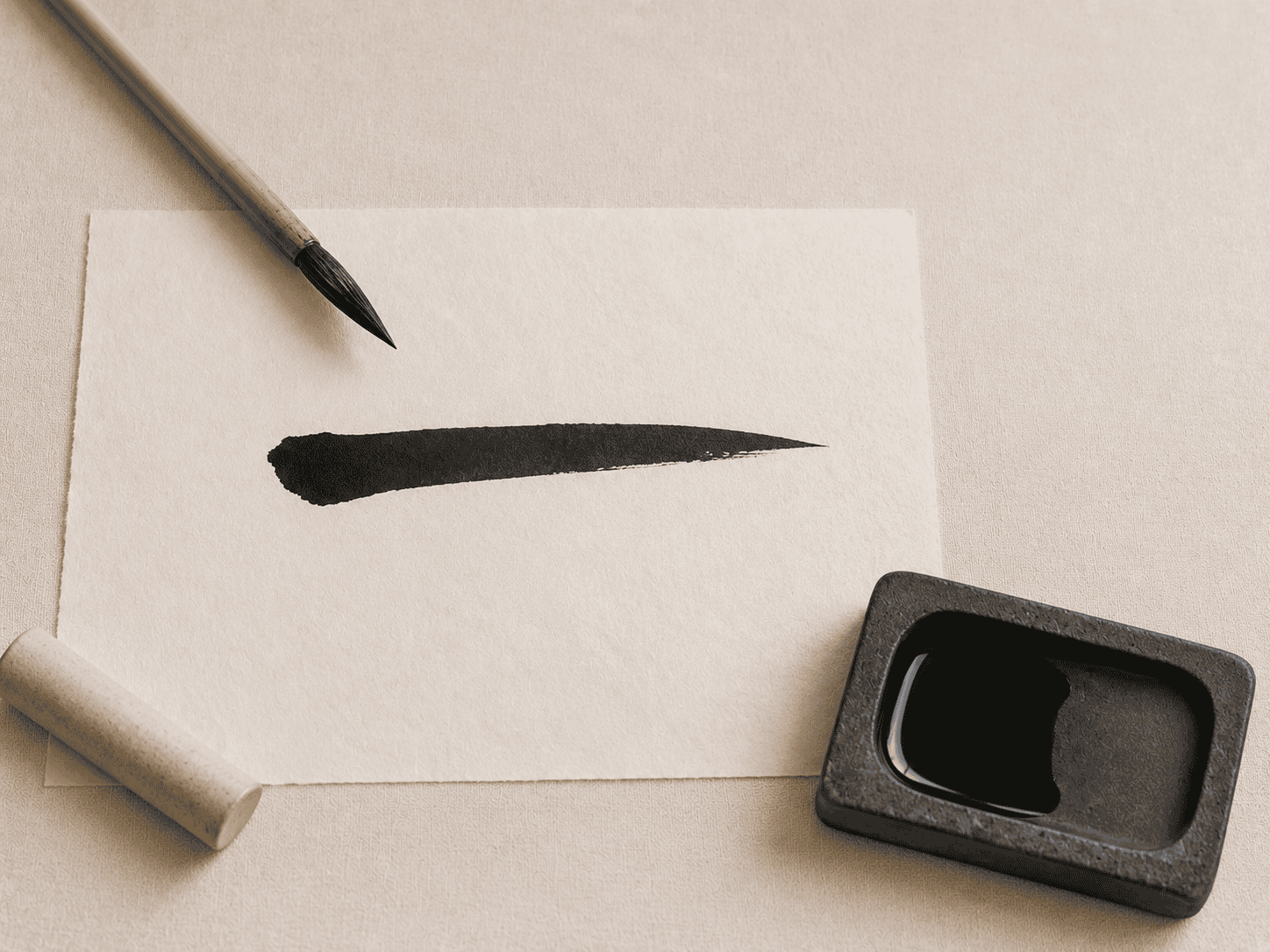 The kanji ichi drawn with brush and ink, showing the single confident stroke the workbook teaches first
