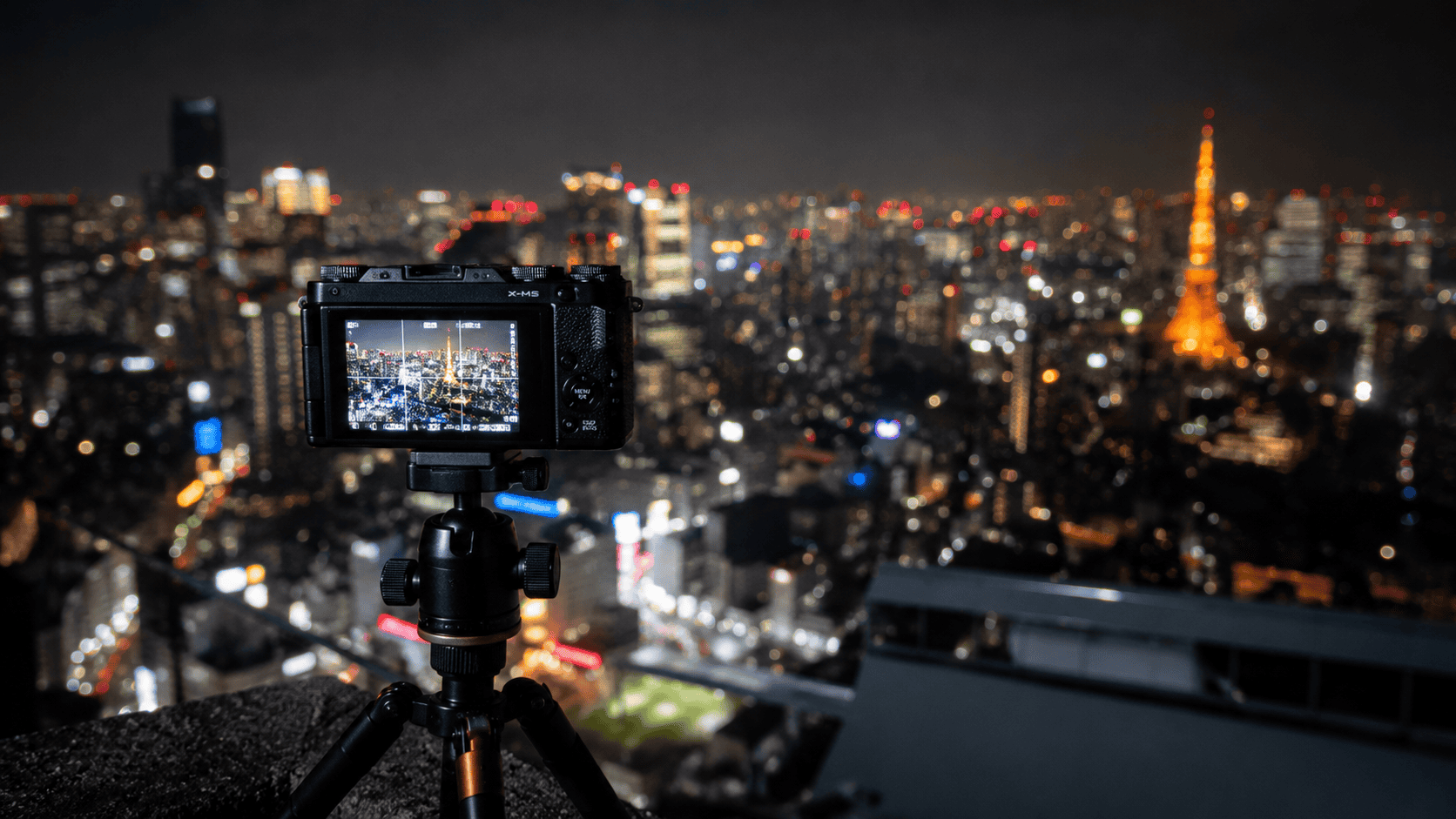 Compact camera on a travel tripod set up for Tokyo night photography