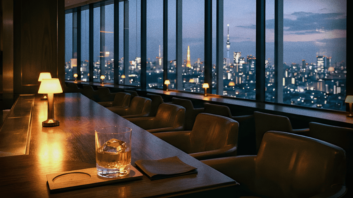 A quiet high-floor hotel bar at dusk with floor-to-ceiling windows over the Tokyo skyline