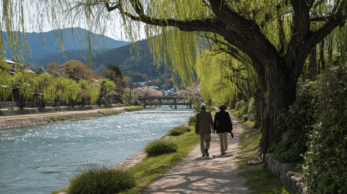 Two people walking together along the Kamo River in Kyoto in spring
