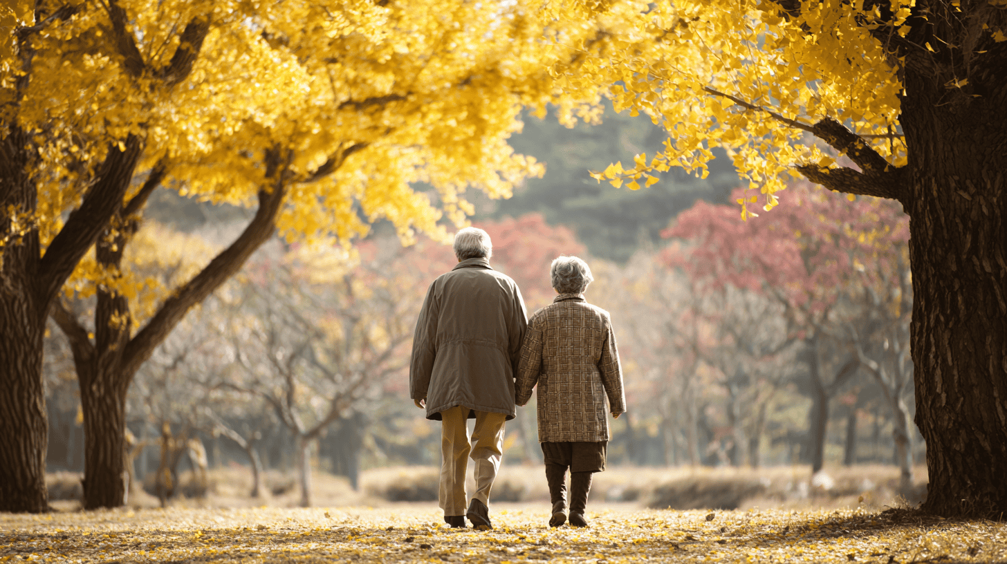 An elderly couple walking arm in arm through a sunny autumn park, a picture of kizuna