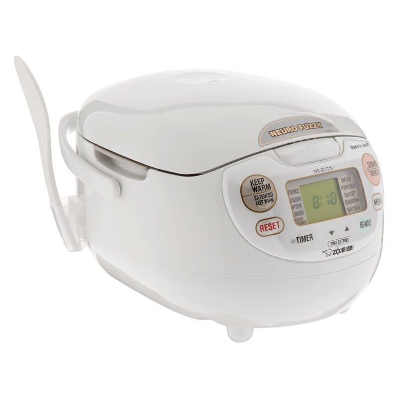 A modern rice cooker steaming fluffy white rice in a bright kitchen.