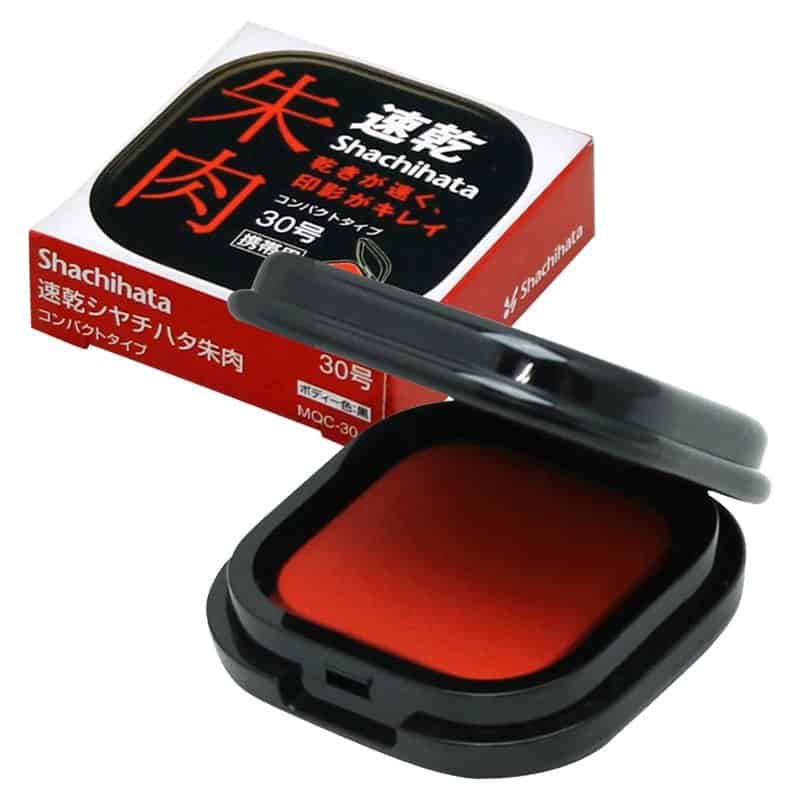 A compact Shachihata vermilion seal ink pad with a round red ink surface