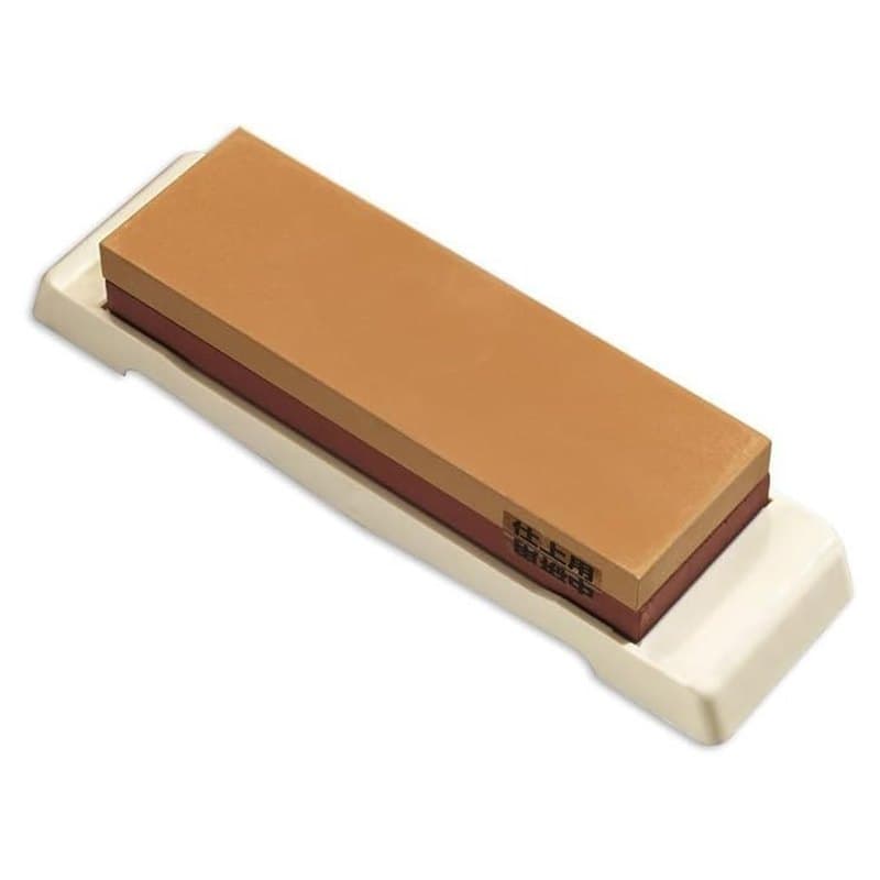 A Naniwa Combi ceramic whetstone with a coarse side and a fine side resting on its base