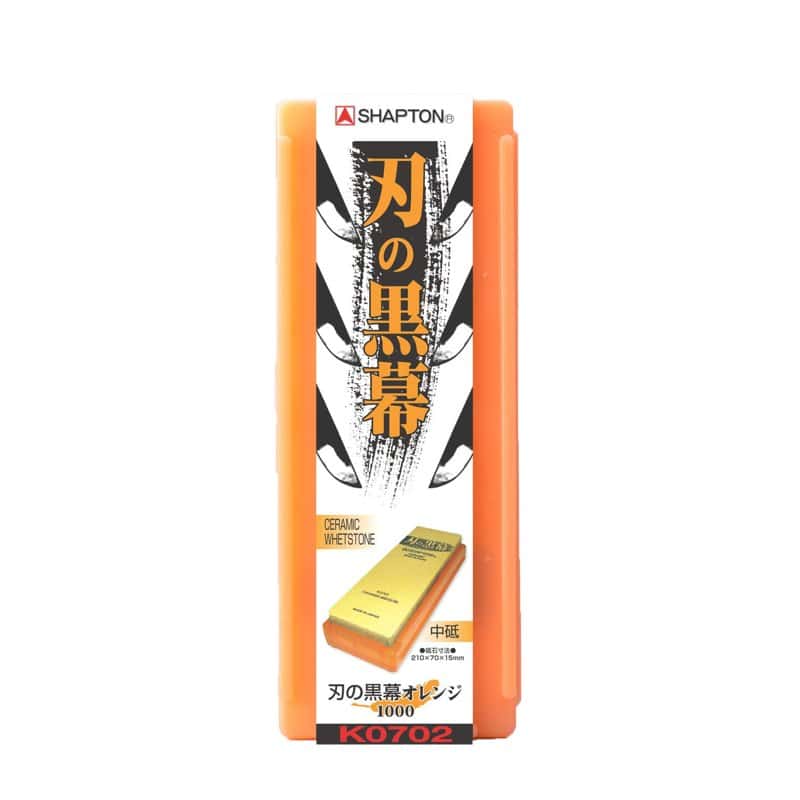 An orange Shapton Kuromaku ceramic whetstone in its box with Japanese lettering