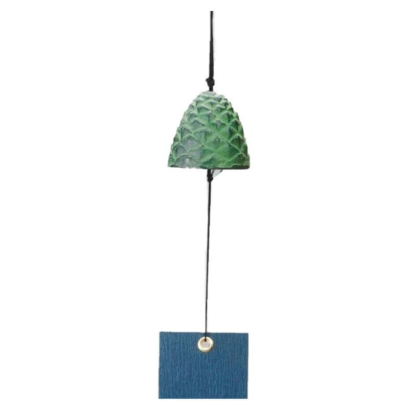 A small green cast-iron wind bell shaped like a pine cone, hanging above a blue paper strip