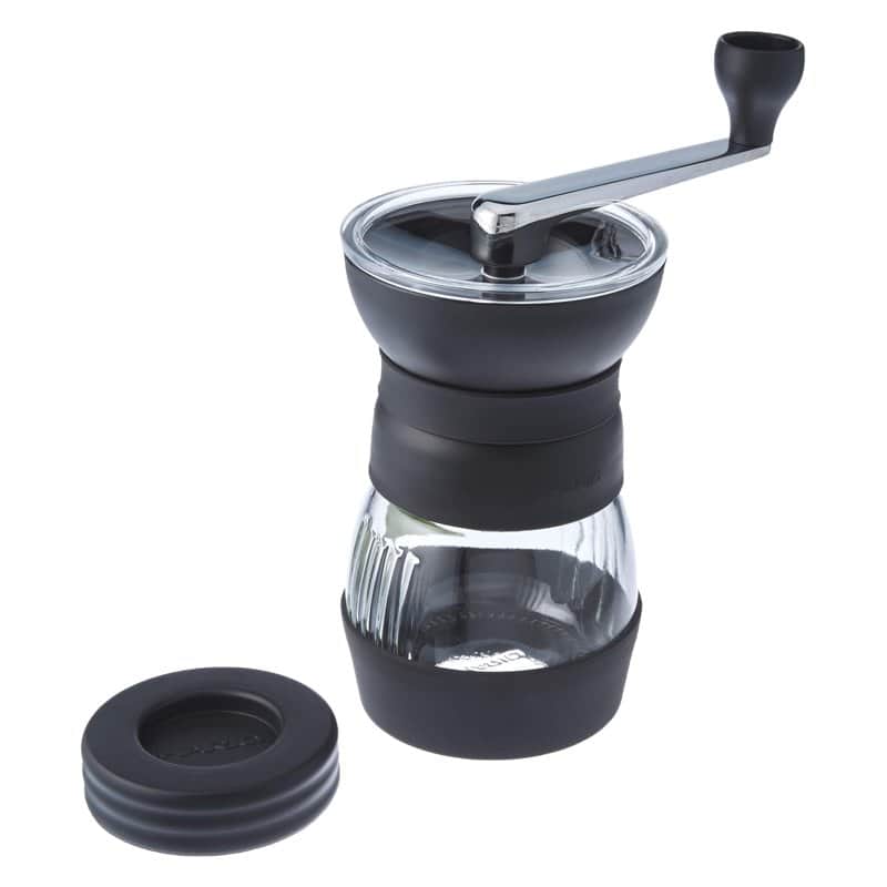 A Hario Skerton Pro hand coffee grinder with a glass base and a black hopper