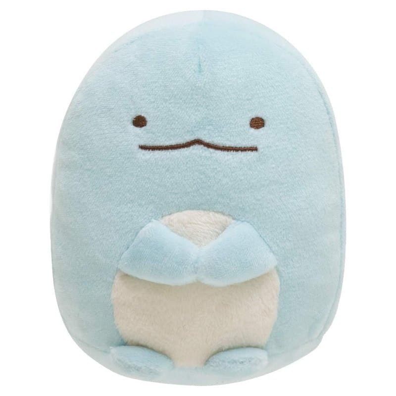 A small blue Sumikko Gurashi Tokage plush with a cream belly