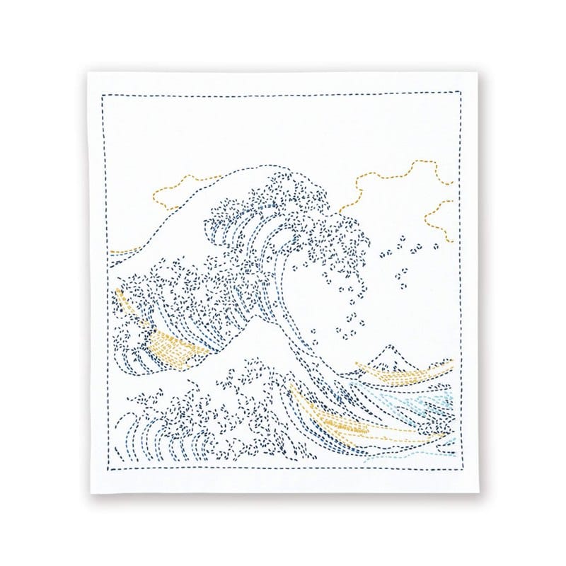 An Olympus sashiko kit printed with Hokusai's Great Wave pattern, with white thread and needle