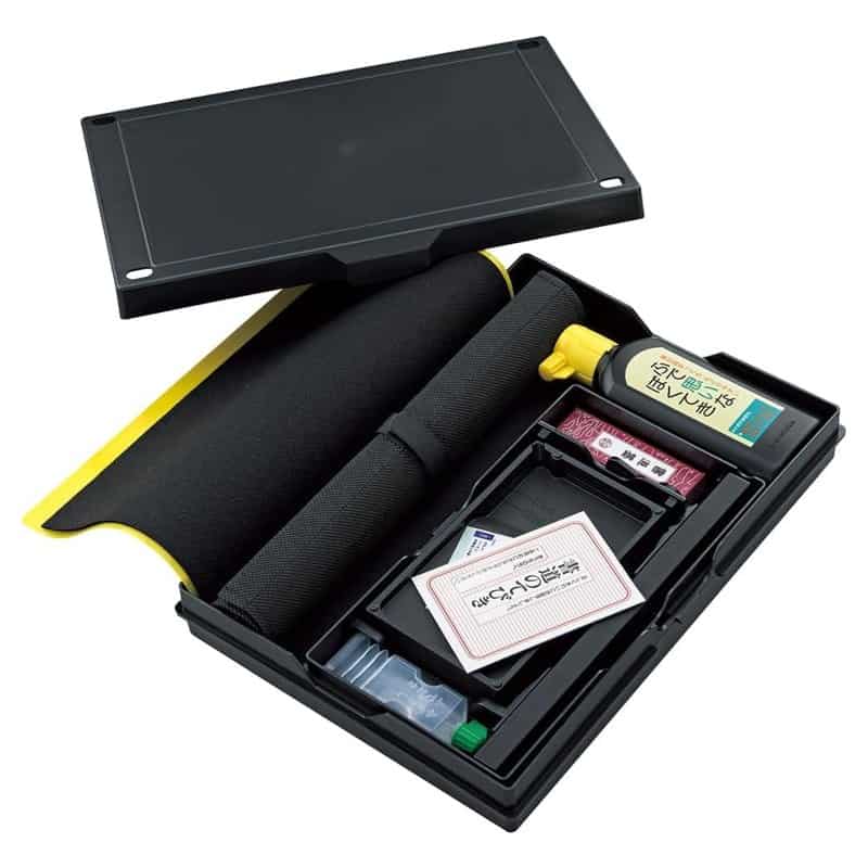 A Kuretake Japanese calligraphy set with brushes, a sumi ink stick and an ink stone