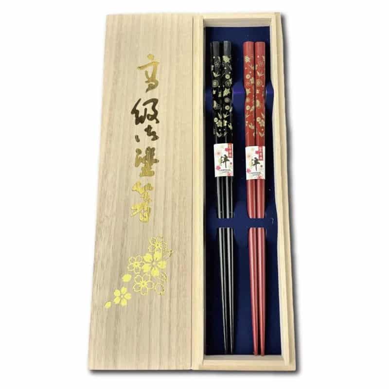 Two pairs of black and red lacquered chopsticks with a crane and turtle pattern, made in Obama, Fukui