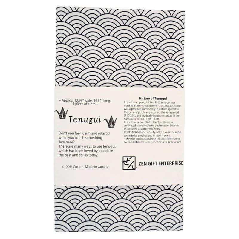 A navy and white cotton tenugui towel printed with the overlapping seigaiha wave pattern