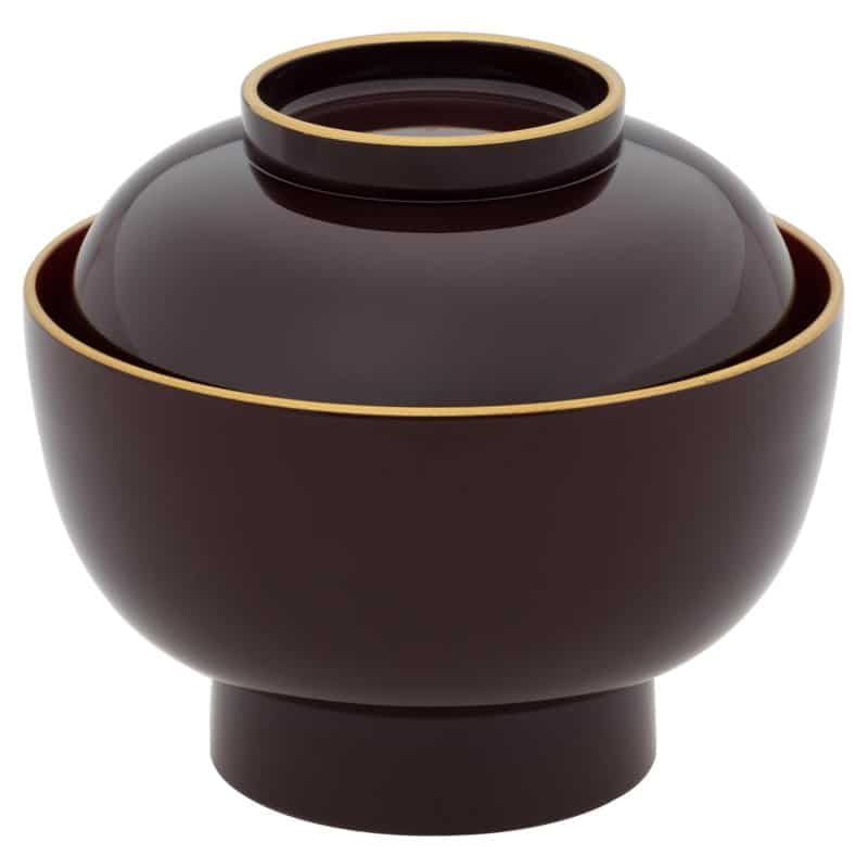 A black and red Yamanaka lacquerware zoni bowl with a lid and gold painted design
