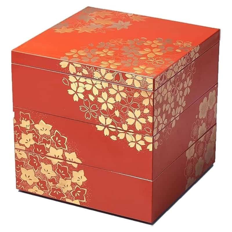 A red three-tier Japanese jubako stacking box with a lid, hand-painted