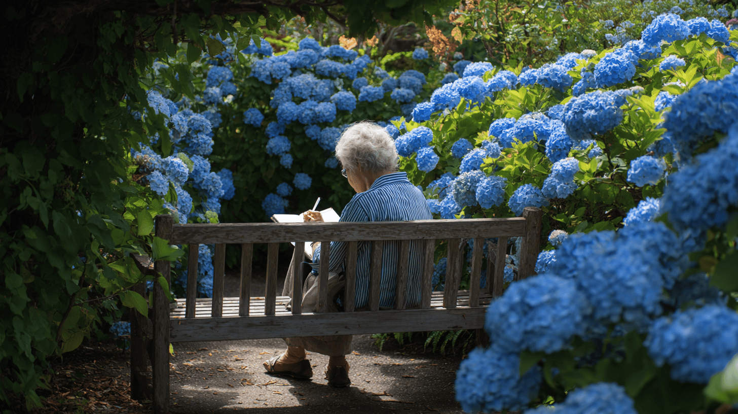 Older woman writing relationship readiness journal prompts on a garden bench among blue hydrangeas